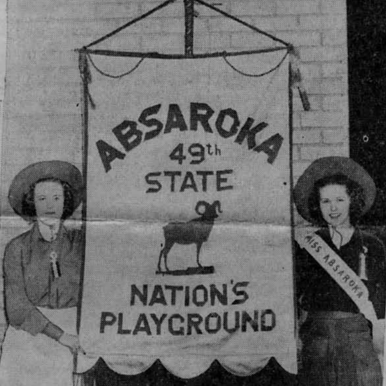 Mrs. Ester Booras and Mrs. Dorothy Wimer with a banner that has the Absaroka State motto on it